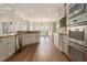 Elegant kitchen featuring stainless steel appliances, granite countertops, and an open layout at 490 Revenna Trl, Fayetteville, GA 30214