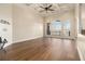 Spacious living room with hardwood floors, large windows, and a coffered ceiling with ceiling fan at 490 Revenna Trl, Fayetteville, GA 30214