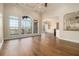 Bright living space with large windows, hardwood floors, and an open layout leading into the kitchen at 490 Revenna Trl, Fayetteville, GA 30214