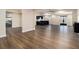 Open-concept room with hardwood floors, bar, and ample natural light at 490 Revenna Trl, Fayetteville, GA 30214