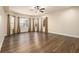 Living room with three windows with curtains, light walls, and hardwood floors at 490 Revenna Trl, Fayetteville, GA 30214
