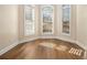 Sunlit sitting area features hardwood floors and large windows at 490 Revenna Trl, Fayetteville, GA 30214