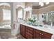 Luxurious bathroom featuring double vanity, granite counters, and soaking tub at 50 Cannonade Ct, Covington, GA 30016