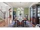 Formal dining room with elegant decor, a chandelier, and a view to the front yard at 50 Cannonade Ct, Covington, GA 30016