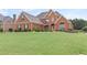 Beautiful home with a large front yard, mature trees, and well-maintained landscaping at 50 Cannonade Ct, Covington, GA 30016