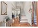 Grand foyer featuring hardwood floors, staircase, and elegant decor setting a welcoming tone at 50 Cannonade Ct, Covington, GA 30016
