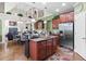 Open-concept kitchen overlooks living spaces, featuring an island with seating and stainless-steel appliances at 50 Cannonade Ct, Covington, GA 30016