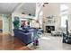 Bright living room boasts a fireplace, vaulted ceilings, and is connected to the kitchen at 50 Cannonade Ct, Covington, GA 30016
