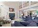 Open concept living room features high ceilings, a fireplace, and seamless transition to the dining area at 50 Cannonade Ct, Covington, GA 30016