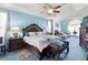 Spacious main bedroom with tray ceiling, elegant furnishings and sitting area at 50 Cannonade Ct, Covington, GA 30016