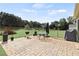 Backyard brick patio with a grill, table, and chairs, perfect for outdoor entertaining at 50 Cannonade Ct, Covington, GA 30016