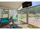 Bright sunroom with outdoor view, comfortable seating, and hardwood flooring at 50 Cannonade Ct, Covington, GA 30016