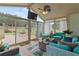 Bright sunroom with outdoor view, comfortable seating, and a ceiling fan at 50 Cannonade Ct, Covington, GA 30016