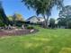 Backyard features a beautifully landscaped yard with a fire pit area and a view of the back of the house at 77 Russell Rd, Lawrenceville, GA 30043