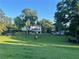 Expansive backyard with lush green grass, mature trees, and fenced perimeter at 77 Russell Rd, Lawrenceville, GA 30043