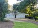 Exterior view of a well-maintained barn with multiple doors and decorative signage at 77 Russell Rd, Lawrenceville, GA 30043