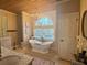 Bright bathroom featuring a soaking tub under a large window, plus double vanity at 77 Russell Rd, Lawrenceville, GA 30043