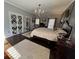 Spacious bedroom featuring hardwood floors, a chandelier, and a comfortable king-size bed at 77 Russell Rd, Lawrenceville, GA 30043