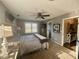 Comfortable bedroom with a ceiling fan, window view, and warm carpet flooring at 77 Russell Rd, Lawrenceville, GA 30043