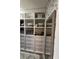 Walk-in closet featuring custom shelving, drawers, and a full-length mirror at 77 Russell Rd, Lawrenceville, GA 30043