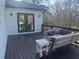 Outdoor deck featuring a wicker sofa and wooded backyard views with French doors leading inside at 77 Russell Rd, Lawrenceville, GA 30043