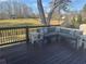 Spacious outdoor deck area featuring a sectional sofa and an expansive view of the backyard at 77 Russell Rd, Lawrenceville, GA 30043