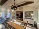 Sunroom dining area featuring rustic chandelier, vaulted ceiling, large windows, and view into the kitchen at 77 Russell Rd, Lawrenceville, GA 30043