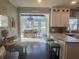 Bright kitchen with stone counters, breakfast bar seating, and adjacent dining area with sunroom views at 77 Russell Rd, Lawrenceville, GA 30043
