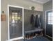 Charming entryway showcasing a built-in mudroom bench, a coat rack, and a view into the kitchen at 77 Russell Rd, Lawrenceville, GA 30043