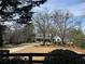 Beautiful two-story home with a long driveway and mature trees creating a picturesque setting at 77 Russell Rd, Lawrenceville, GA 30043