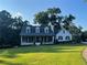 Well-manicured front lawn and landscaping frame this charming two-story home at 77 Russell Rd, Lawrenceville, GA 30043
