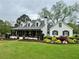 Charming home featuring a manicured lawn, front porch, and classic architectural details at 77 Russell Rd, Lawrenceville, GA 30043