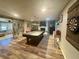 Spacious game room with a pool table, dartboard, and adjacent seating area at 77 Russell Rd, Lawrenceville, GA 30043