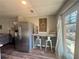Kitchen nook features a large refrigerator, seating, and a window with natural light at 77 Russell Rd, Lawrenceville, GA 30043