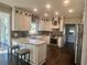 Bright kitchen featuring white cabinetry, stainless steel appliances, marble countertops, and dark hardwood floors at 77 Russell Rd, Lawrenceville, GA 30043