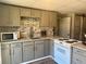 Charming kitchen with gray cabinets, brick backsplash, and modern appliances at 77 Russell Rd, Lawrenceville, GA 30043