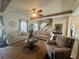 Cozy living room with a ceiling fan, two sofas, an area rug and a decorative staircase at 77 Russell Rd, Lawrenceville, GA 30043
