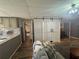 Open living area flowing to kitchen with sliding barn doors for privacy at 77 Russell Rd, Lawrenceville, GA 30043