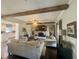 Open living room features exposed beams, a brick fireplace, and views into the kitchen at 77 Russell Rd, Lawrenceville, GA 30043
