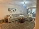 Comfortable living room area with a large sectional couch, chandelier, and cozy rug at 77 Russell Rd, Lawrenceville, GA 30043