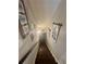 View of a wooden staircase with decorative accents and a dark handrail at 77 Russell Rd, Lawrenceville, GA 30043