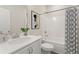 Clean bathroom with a vanity, toilet, and bathtub with shower and patterned shower curtain at 18 Torry Pines Cir, Villa Rica, GA 30180