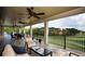 Expansive covered porch with ceiling fans, lounge chairs, and golf course views at 18 Torry Pines Cir, Villa Rica, GA 30180