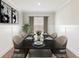 Cozy dining room with modern table setting, wainscoting, and soft natural light from the window at 18 Torry Pines Cir, Villa Rica, GA 30180