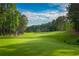 Scenic view of a meticulously maintained golf course with rolling hills and towering trees at 18 Torry Pines Cir, Villa Rica, GA 30180