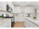 Well-lit kitchen featuring white cabinetry, stainless steel appliances, and granite countertops at 18 Torry Pines Cir, Villa Rica, GA 30180