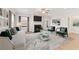 Elegant living room with fireplace, hardwood floors, modern furniture, and ample natural light at 18 Torry Pines Cir, Villa Rica, GA 30180