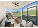Relaxing screened-in patio with comfortable seating, ceiling fan, and serene backyard views at 18 Torry Pines Cir, Villa Rica, GA 30180