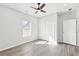 Bright bedroom with gray walls, hardwood floors, ceiling fan, window, and closet doors at 340 Old Sudie Rd, Hiram, GA 30141