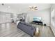 Bright living room with stylish gray flooring, a modern ceiling fan, and an open layout connected to the kitchen at 340 Old Sudie Rd, Hiram, GA 30141